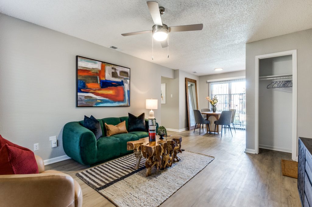 the living room has a ceiling fan and a couch at The  Reid Apartments