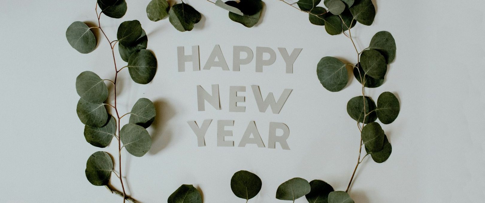 happy new year greeting card with eucalyptus leaves at The  Reid Apartments