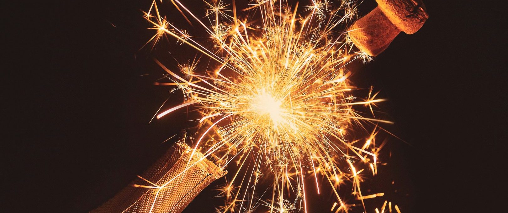 a bottle of champagne with sparklers at The  Reid Apartments